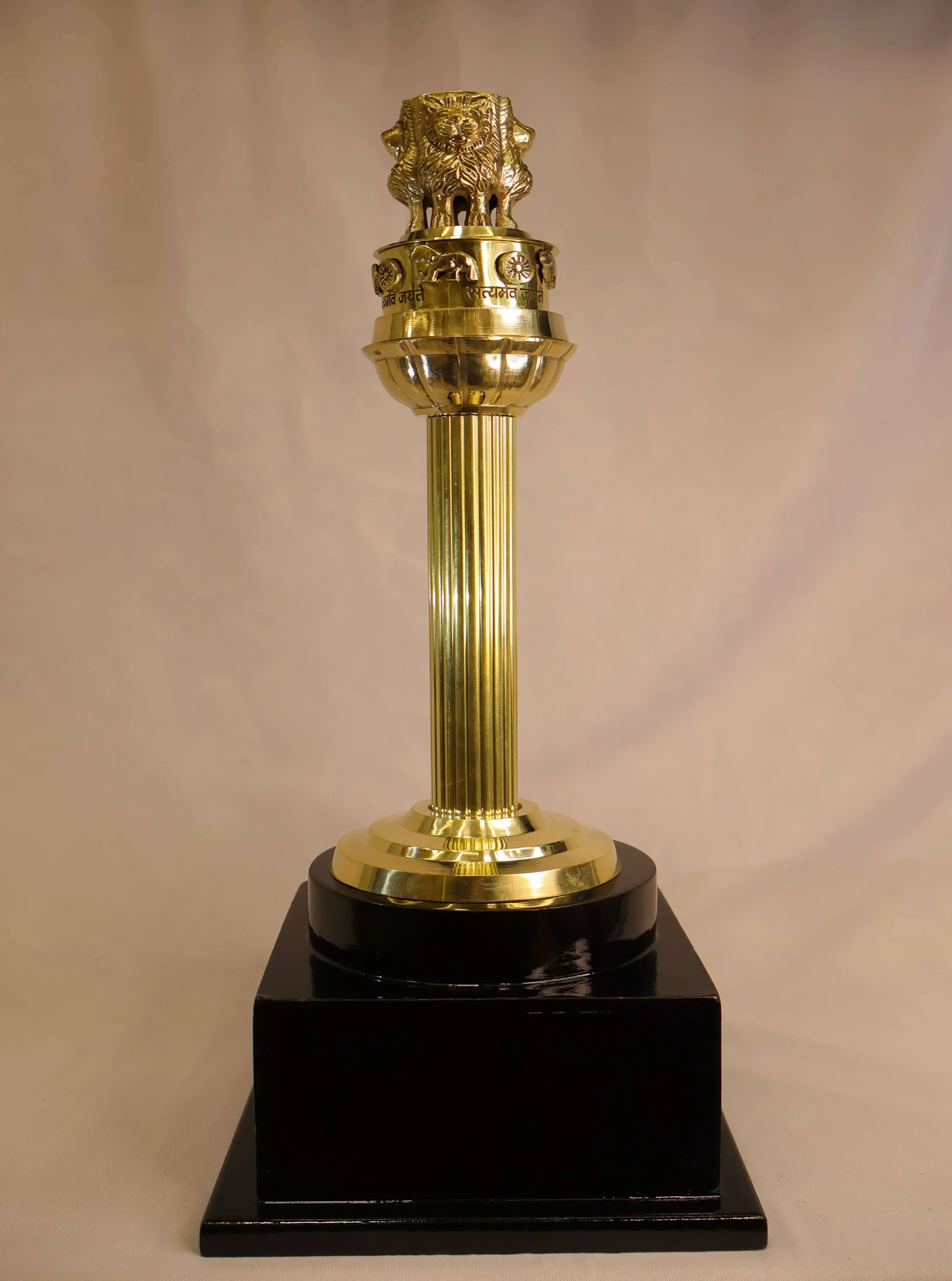 Brass Ashok Stambh on Black Wooden Base Brass Ashok Stambh on Black Wooden Base