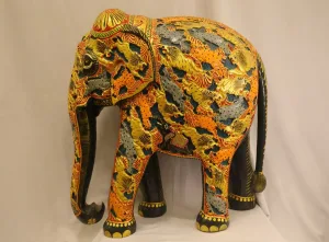 Large hand-painted wooden elephant statue with vibrant yellow, orange and black foliate and animal motifs — decorative Indian folk art sculpture.