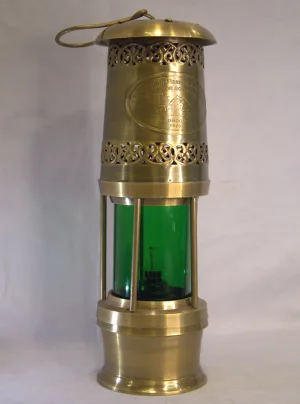 Antique brass safety lamp with green glass lens, brass cage and “London 1920”