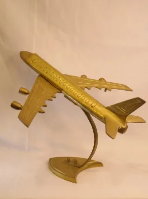 Vintage brass airplane showpiece on curved stand — decorative aviation model