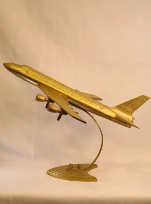 Vintage brass airplane showpiece on curved stand — decorative aviation model