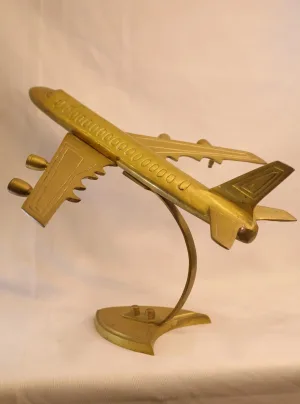 Vintage brass airplane showpiece on curved stand — decorative aviation model